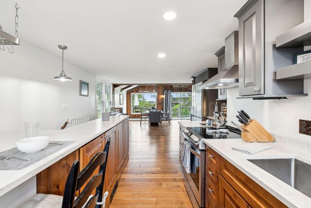 1081 Kings Hwy, Kennebunkport, ME 04046 - kitchen featuring electric range, wall chimney range hood, light wood-style flooring, light stone counters, and recessed lighting