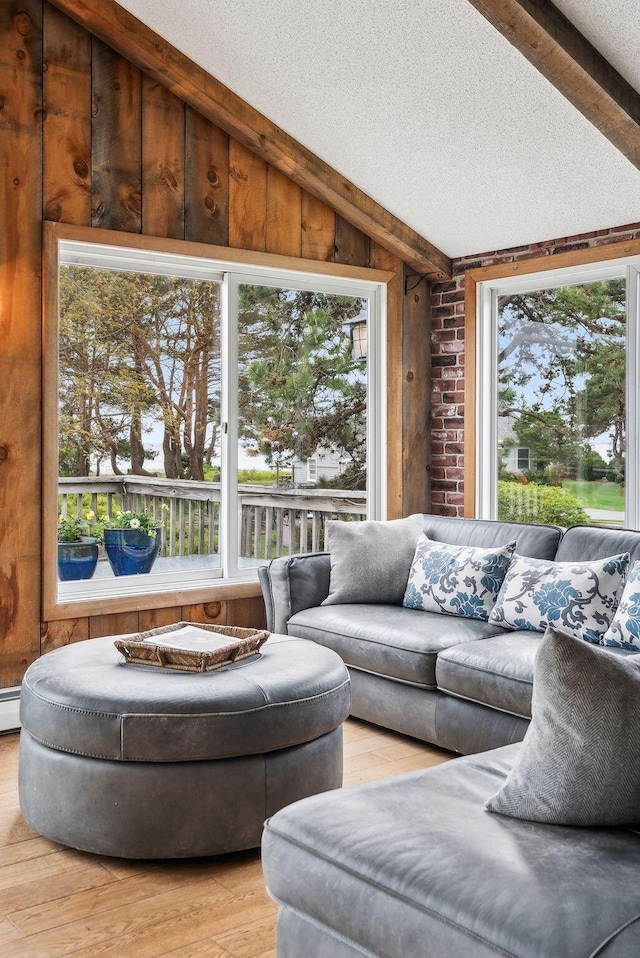 1081 Kings Hwy, Kennebunkport, ME 04046 - living area with light wood-style flooring, wooden walls, and a textured ceiling