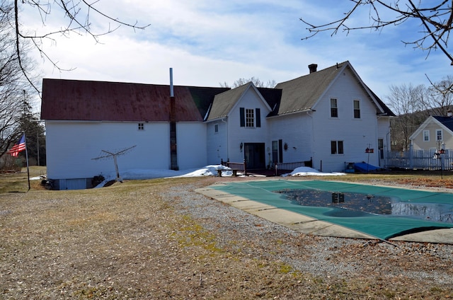 23 Park St, West Paris, ME 04289 - back of house with a patio, a chimney, fence, and a covered pool