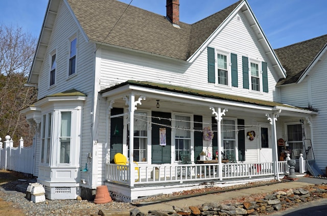 23 Park St, West Paris, ME 04289 - view of front of house with covered porch, a chimney, and a shingled roof
