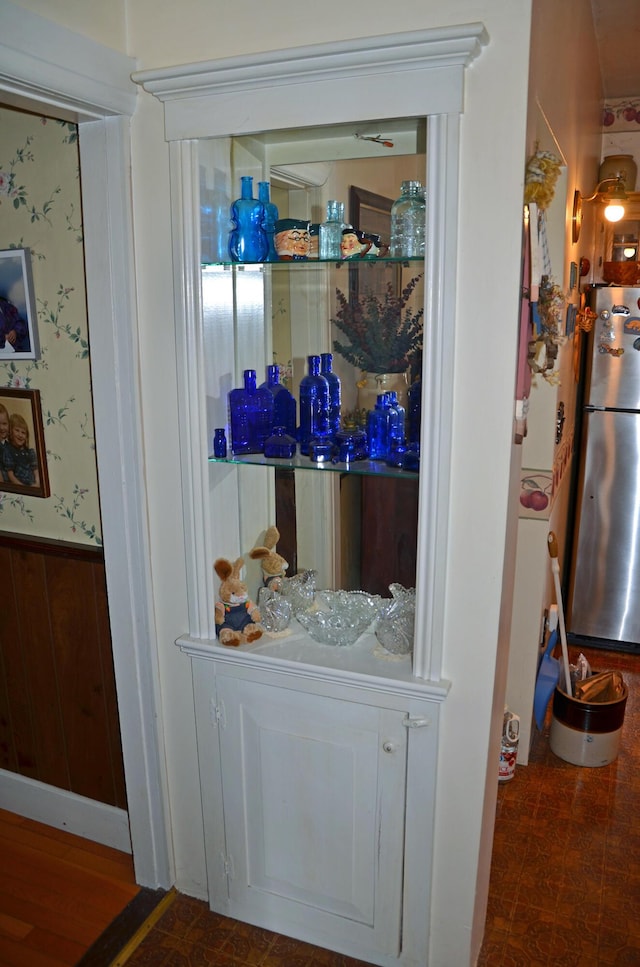 23 Park St, West Paris, ME 04289 - interior details with wallpapered walls, wainscoting, and freestanding refrigerator