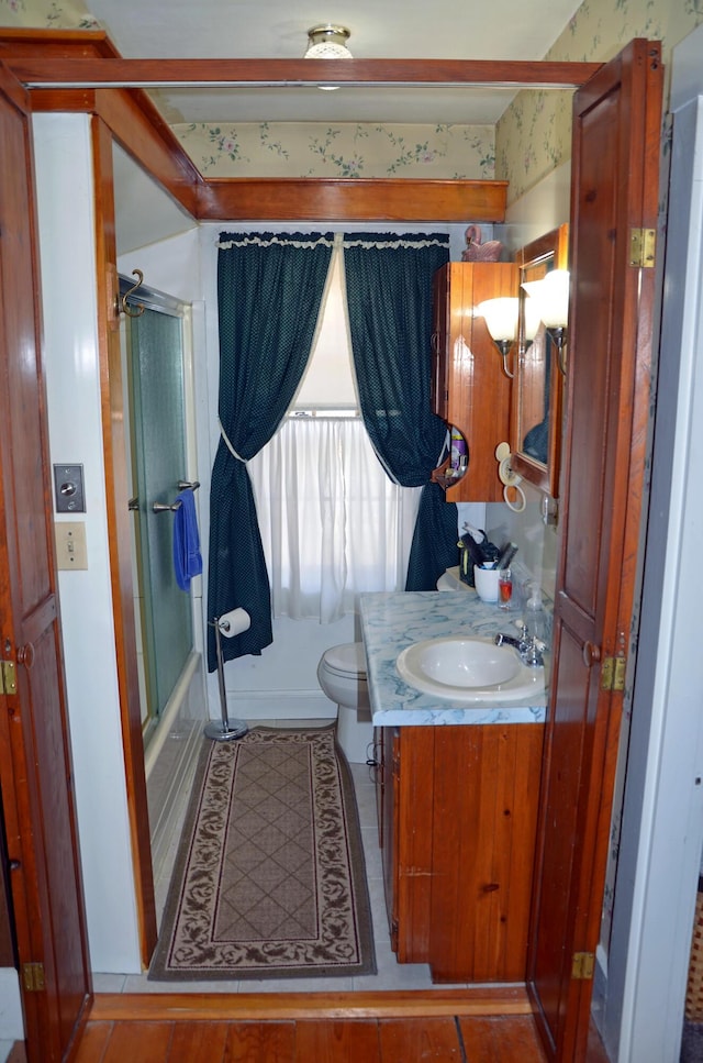 23 Park St, West Paris, ME 04289 - full bath with bath / shower combo with glass door, toilet, tile patterned flooring, and vanity