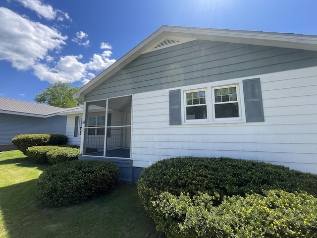 45 Vermont St, Millinocket, ME 04462 - view of side of property featuring a sunroom and a yard