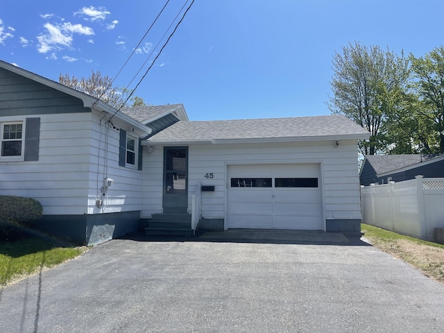 45 Vermont St, Millinocket, ME 04462 - single story home with an attached garage, roof with shingles, and driveway