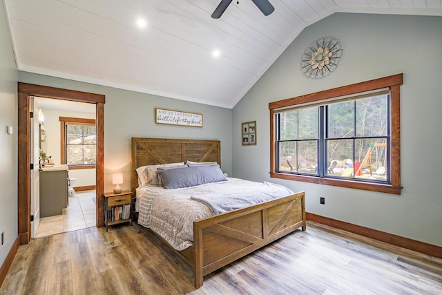 bedroom featuring lofted ceiling, ceiling fan, baseboards, and wood finished floors