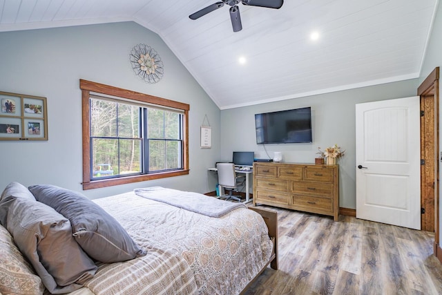 bedroom with baseboards, wood finished floors, a ceiling fan, and lofted ceiling