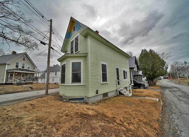 view of side of home featuring driveway