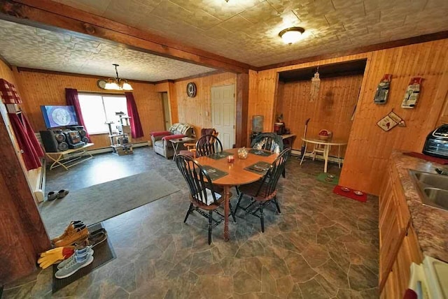 dining area featuring wood walls and an inviting chandelier