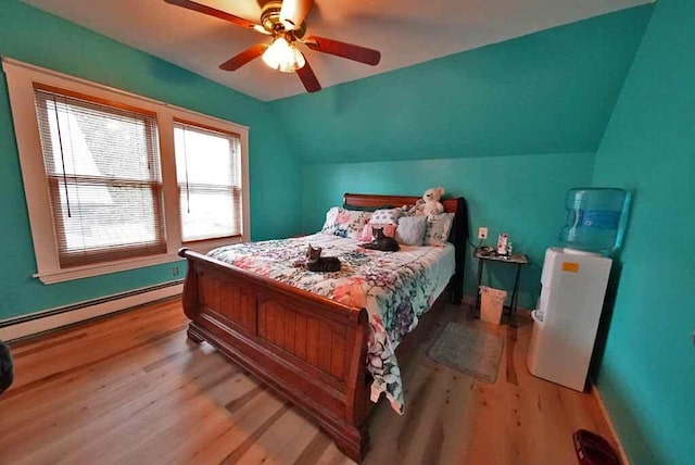bedroom with light wood-style flooring, a baseboard radiator, baseboards, a ceiling fan, and vaulted ceiling