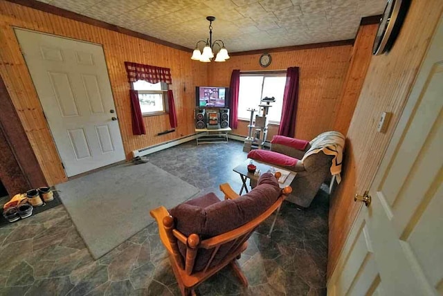 living room featuring a wealth of natural light, a chandelier, a baseboard heating unit, and wooden walls