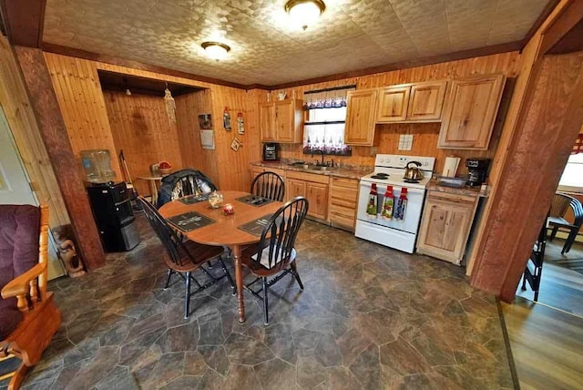 kitchen with light countertops, wooden walls, an ornate ceiling, a sink, and white range with electric cooktop