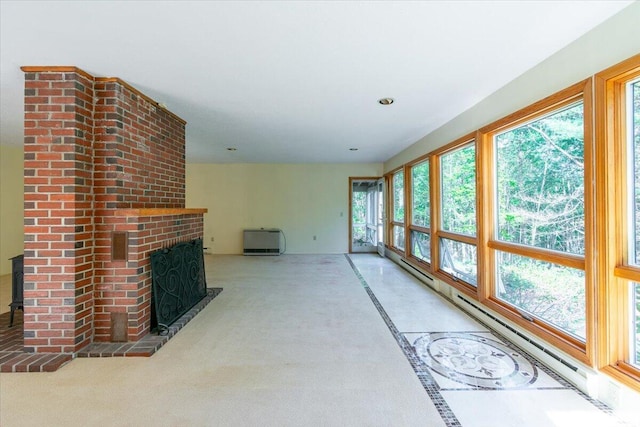unfurnished sunroom with a baseboard radiator, recessed lighting, heating unit, and carpet