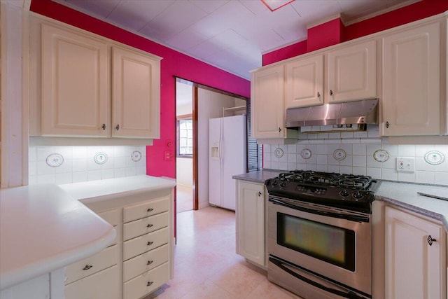 kitchen with white fridge with ice dispenser, stainless steel gas range, under cabinet range hood, white cabinetry, and backsplash