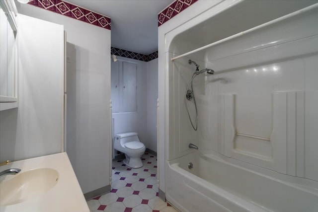 full bathroom featuring toilet, tile patterned floors, a sink, and shower / bathtub combination