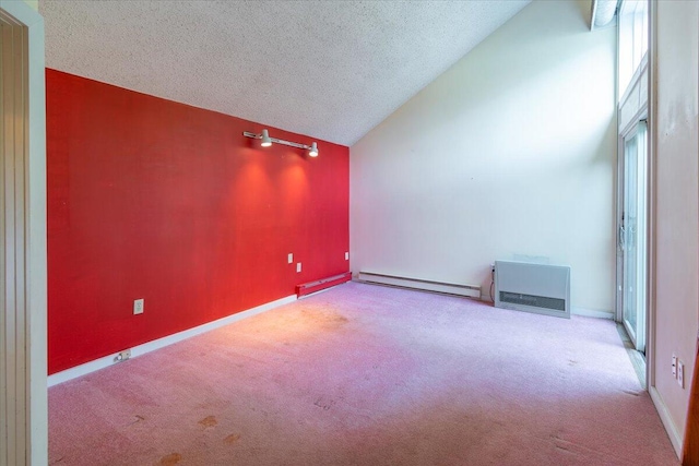 interior space featuring baseboards, a baseboard heating unit, vaulted ceiling, carpet flooring, and a textured ceiling