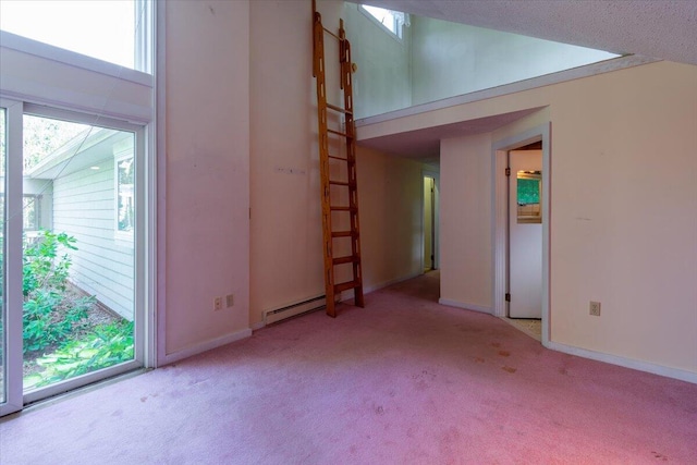 interior space with baseboard heating, baseboards, and carpet