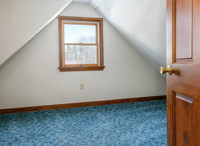 bonus room with lofted ceiling, baseboards, and carpet flooring