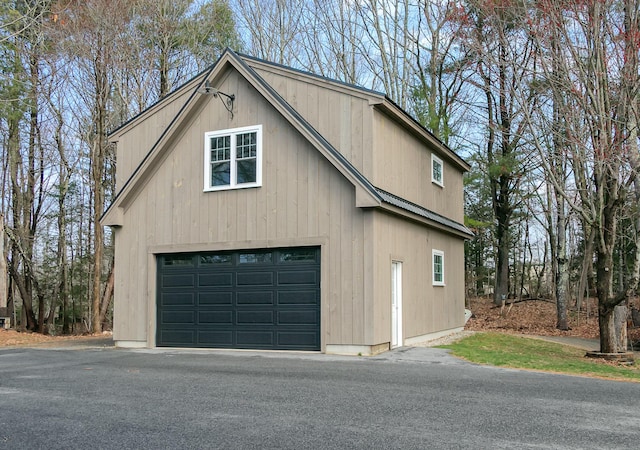 view of side of home with a detached garage