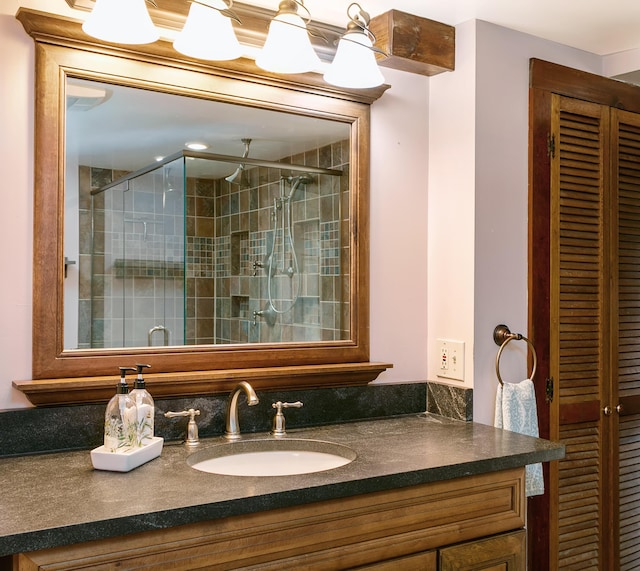 full bathroom with a shower stall and vanity