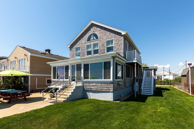 22 Gold Ribbon Dr, Wells, ME 04090 - view of front of home with a front yard, a sunroom, a patio area, fence, and stairs