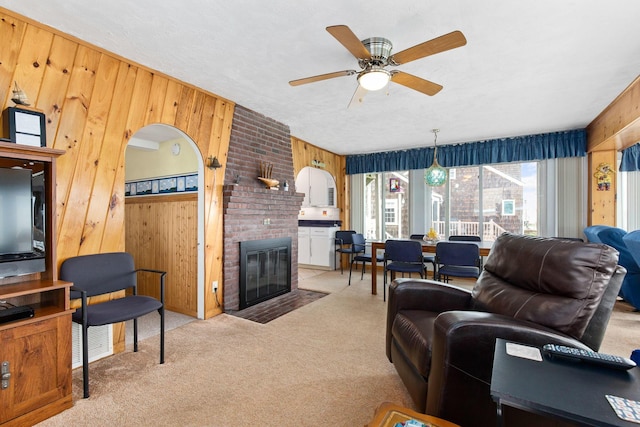 22 Gold Ribbon Dr, Wells, ME 04090 - carpeted living room featuring wood walls, ceiling fan, visible vents, and a fireplace