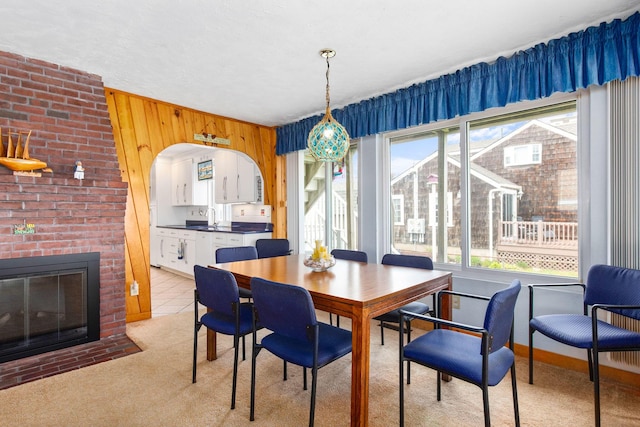 22 Gold Ribbon Dr, Wells, ME 04090 - dining area with wood walls, light colored carpet, and a fireplace
