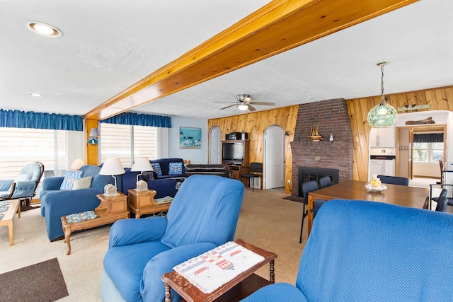 22 Gold Ribbon Dr, Wells, ME 04090 - carpeted living room with wooden walls, beam ceiling, and plenty of natural light