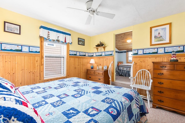 22 Gold Ribbon Dr, Wells, ME 04090 - carpeted bedroom featuring wood walls, a ceiling fan, and a wainscoted wall