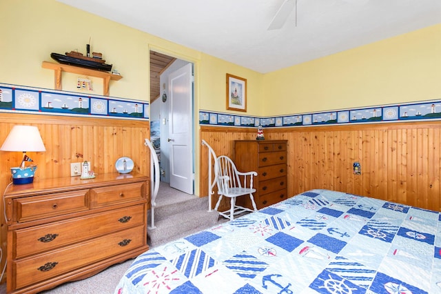 22 Gold Ribbon Dr, Wells, ME 04090 - carpeted bedroom featuring wooden walls, ceiling fan, and a wainscoted wall