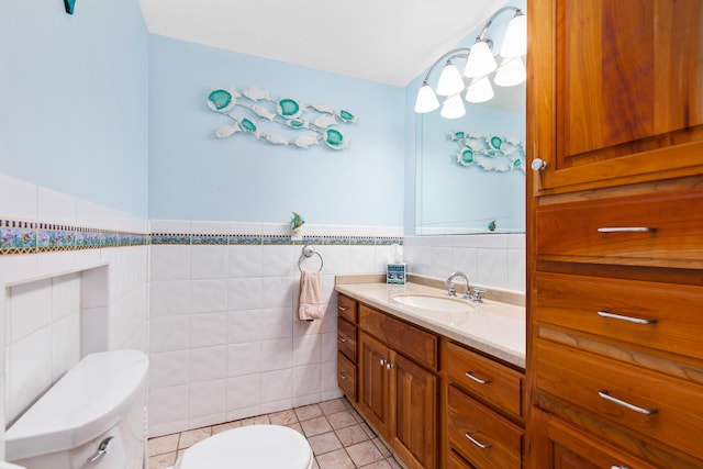 22 Gold Ribbon Dr, Wells, ME 04090 - half bath featuring toilet, tile walls, a wainscoted wall, vanity, and tile patterned floors