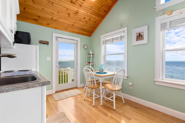22 Gold Ribbon Dr, Wells, ME 04090 - dining space with wood ceiling, light wood-style flooring, baseboards, and lofted ceiling