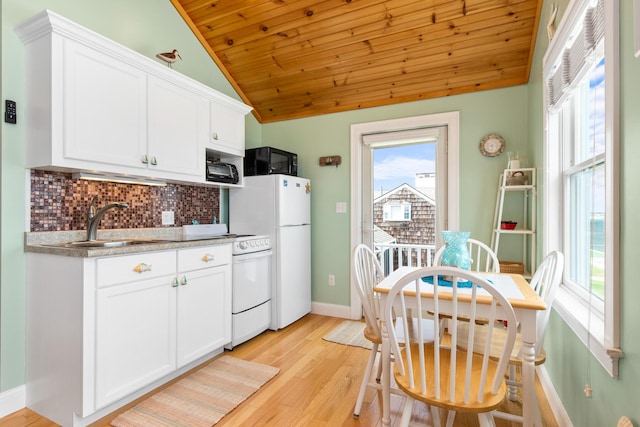 22 Gold Ribbon Dr, Wells, ME 04090 - kitchen featuring vaulted ceiling, white appliances, white cabinetry, light wood-style floors, and decorative backsplash