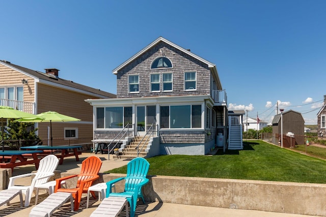 22 Gold Ribbon Dr, Wells, ME 04090 - back of property with a patio area, a sunroom, stairs, a yard, and fence