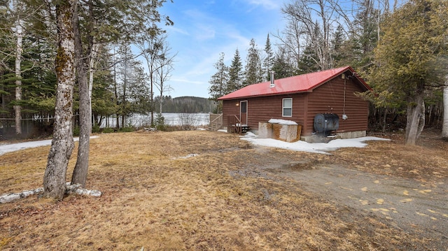 119 W Conroy Lake Rd, Monticello, ME 04760 - view of home's exterior with metal roof and log veneer siding