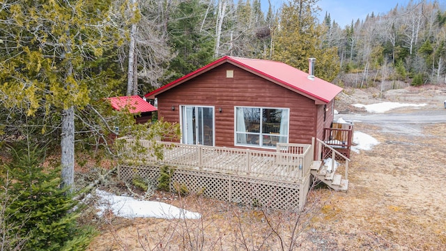 119 W Conroy Lake Rd, Monticello, ME 04760 - view of property exterior featuring metal roof, a deck, a view of trees, and log veneer siding