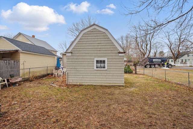 exterior space with an outdoor structure and fence