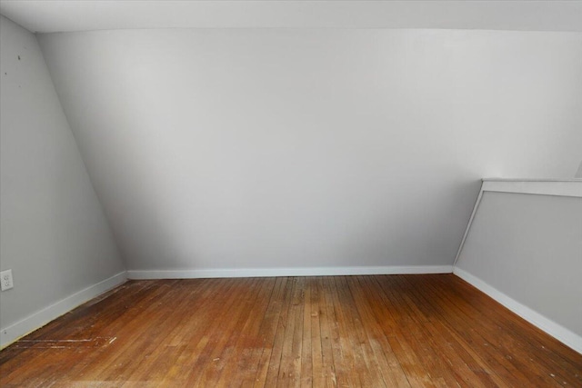 empty room featuring wood-type flooring and baseboards