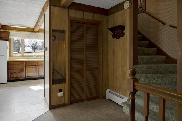 198 Hooper Rd, Shapleigh, ME 04076 - stairway with wooden walls, a baseboard radiator, beamed ceiling, and carpet