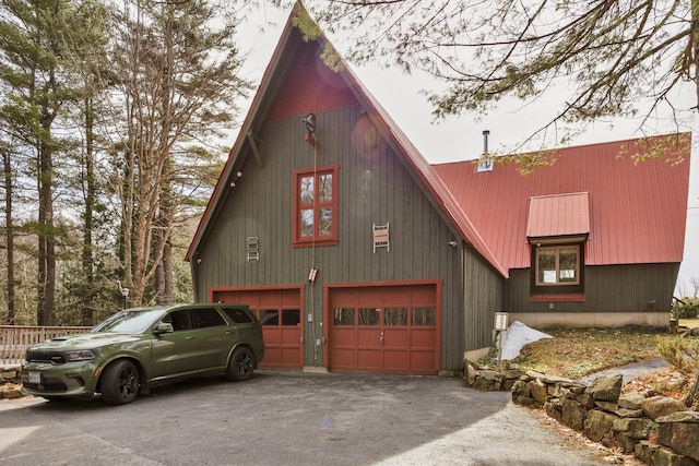 198 Hooper Rd, Shapleigh, ME 04076 - view of side of property with aphalt driveway, a garage, and metal roof