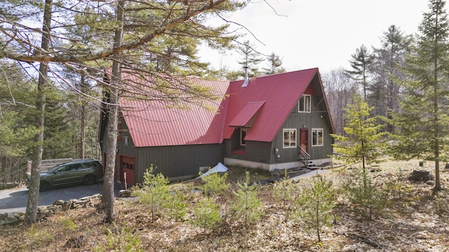 198 Hooper Rd, Shapleigh, ME 04076 - view of front of house with an attached garage, aphalt driveway, and metal roof
