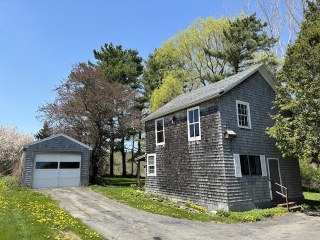 20 Westbrook St, South Thomaston, ME 04858 - view of side of home with an outdoor structure, a garage, and asphalt driveway