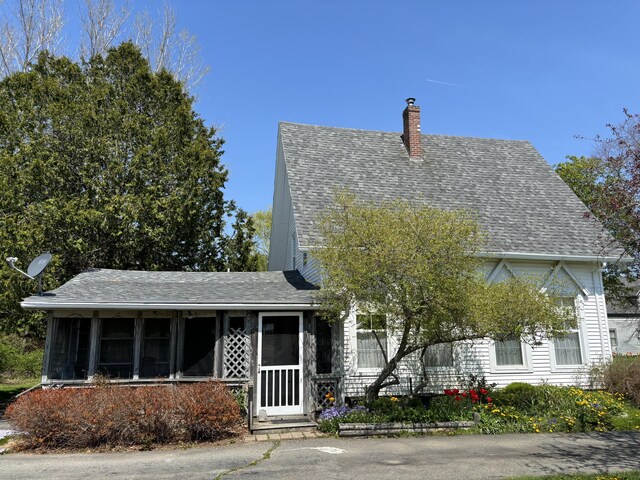 20 Westbrook St, South Thomaston, ME 04858 - view of front of home featuring a sunroom, a chimney, and roof with shingles