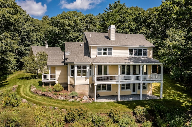 21 Bristol Dr, Rockport, ME 04856 - rear view of house with a patio, a shingled roof, a chimney, and a lawn