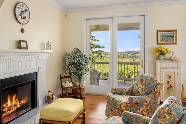 21 Bristol Dr, Rockport, ME 04856 - sitting room featuring wood finished floors, a lit fireplace, crown molding, and a healthy amount of sunlight