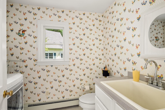 21 Bristol Dr, Rockport, ME 04856 - bathroom with vanity, baseboard heating, wallpapered walls, and toilet