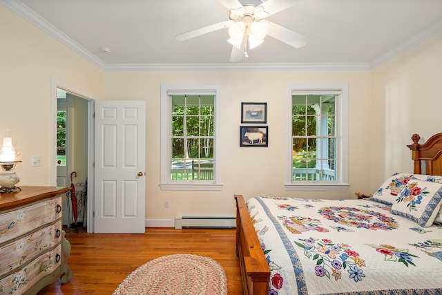 21 Bristol Dr, Rockport, ME 04856 - bedroom with ornamental molding, multiple windows, wood finished floors, and baseboard heating