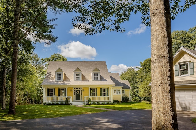 21 Bristol Dr, Rockport, ME 04856 - cape cod-style house featuring a front yard and covered porch
