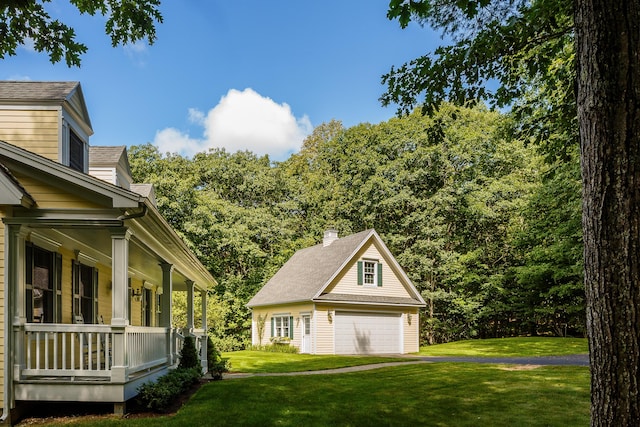 21 Bristol Dr, Rockport, ME 04856 - view of side of property with a yard, a detached garage, a porch, and an outdoor structure