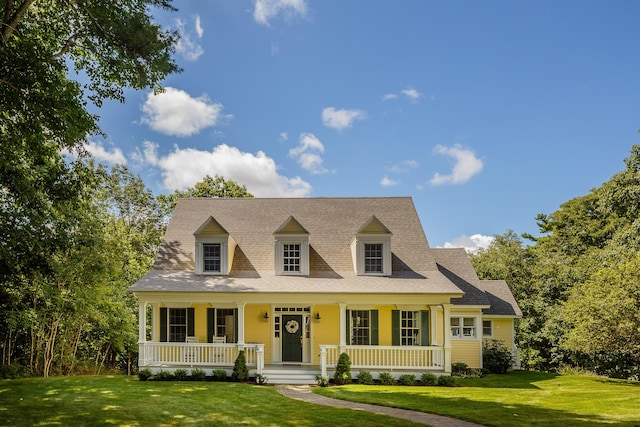21 Bristol Dr, Rockport, ME 04856 - new england style home featuring a front lawn, covered porch, and roof with shingles