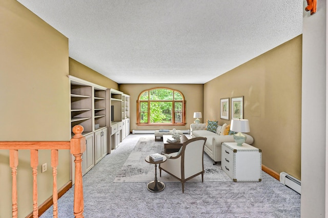 carpeted living area with baseboards, a textured ceiling, a baseboard heating unit, and baseboard heating